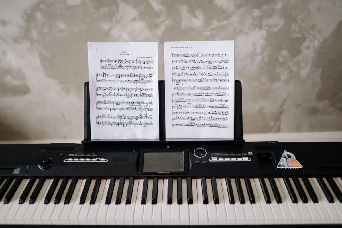 A digital piano keyboard beside a bright window